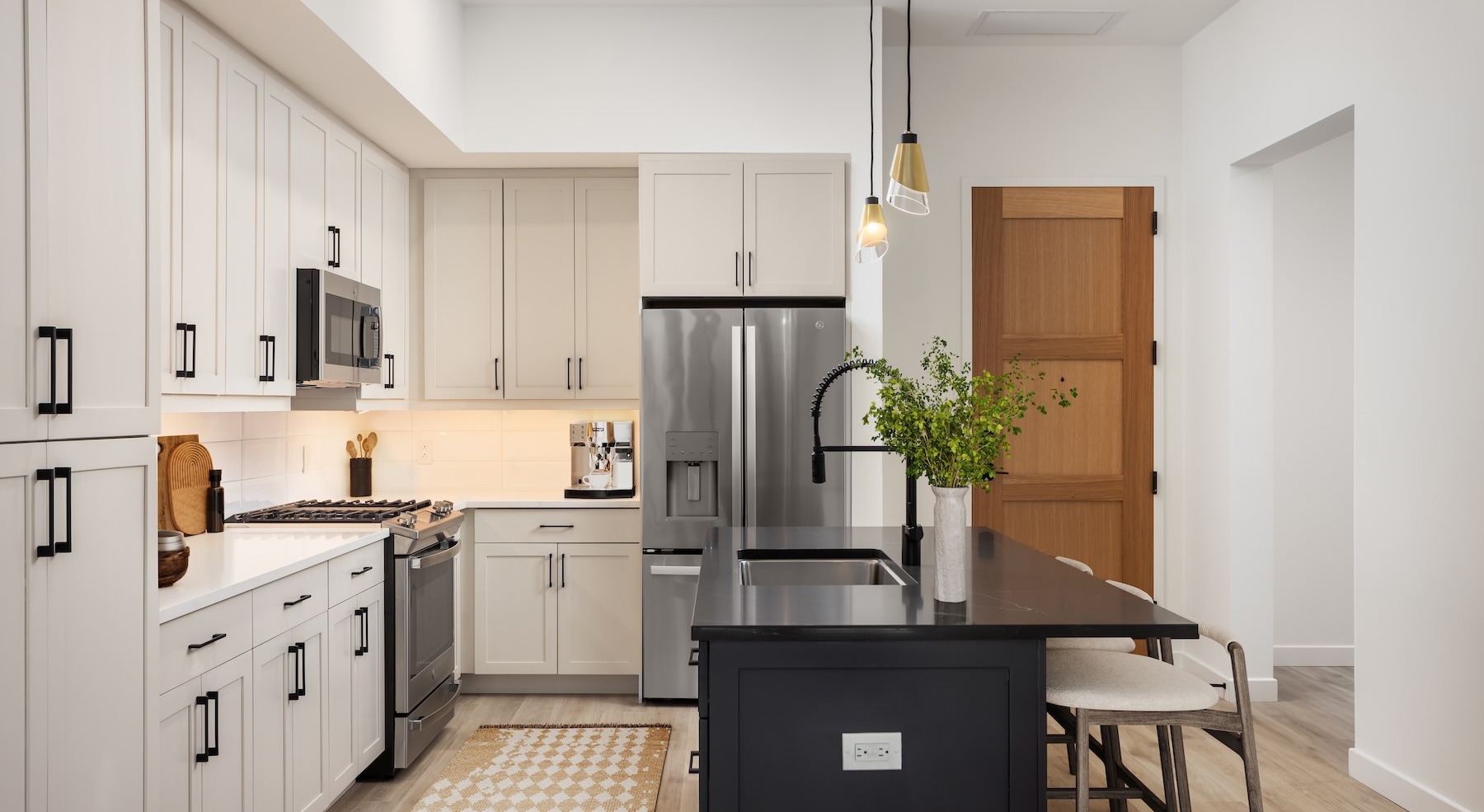 kitchen with an island and sink with white cabinets