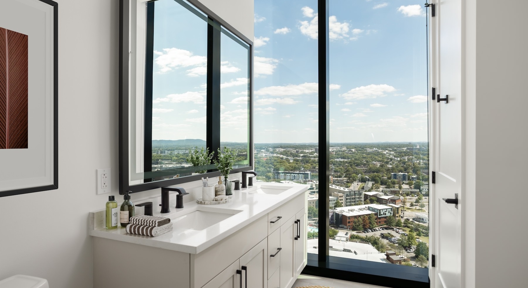 bathroom with sinks mirrors and large windows
