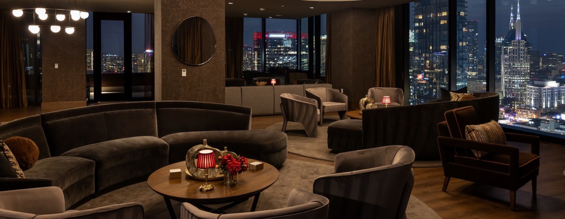 a lounge with seating and tables with a view of a city