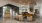 a room with a large glass wall and a couch and a person walking
